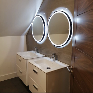 two 600mm round bluetooth bathroom mirrors with black frames above sinks in bathroom