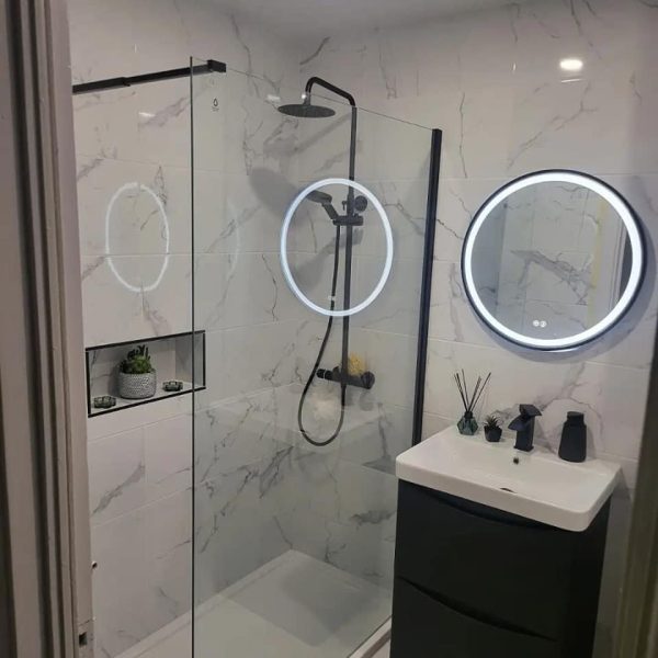 Black Trim 600mm Round LED Mirror in a brand new bathroom with black features