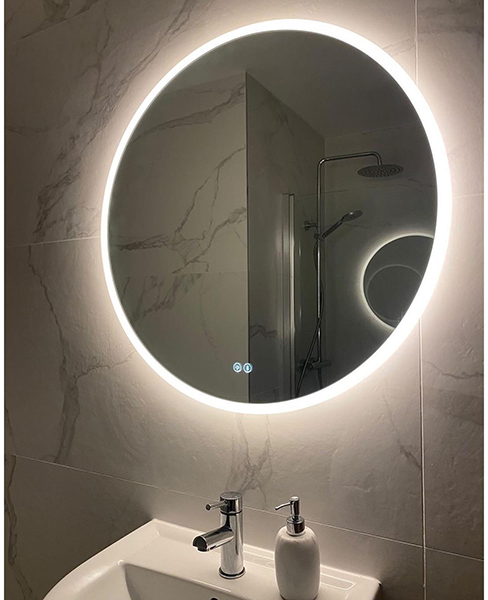 round bluetooth bathroom mirror fixed above a seat