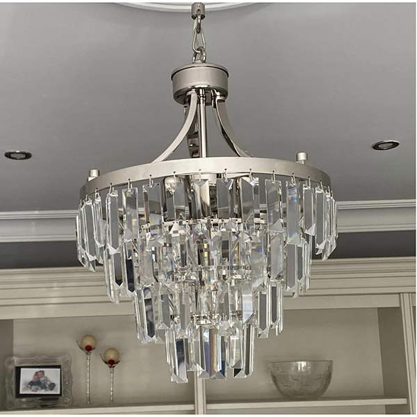 A Crystal Tiered Chandelier Hanging in a living room