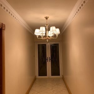 hallway with chandelier at the bottom