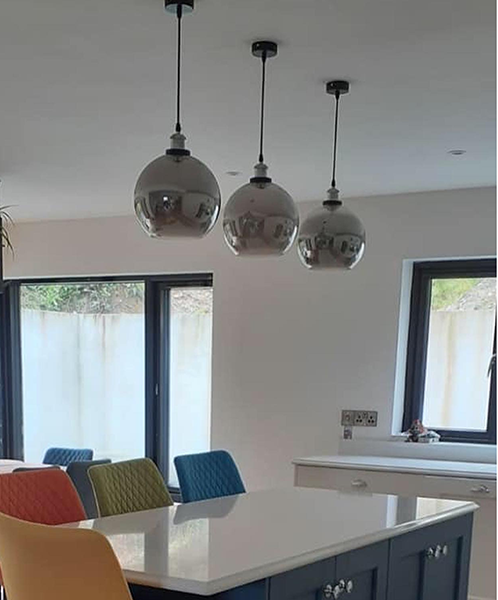 kitchen with smoked chrome pendant lights above island