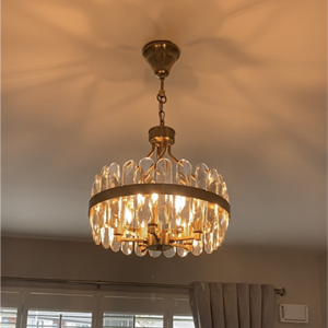 golden chandelier illuminated in living room