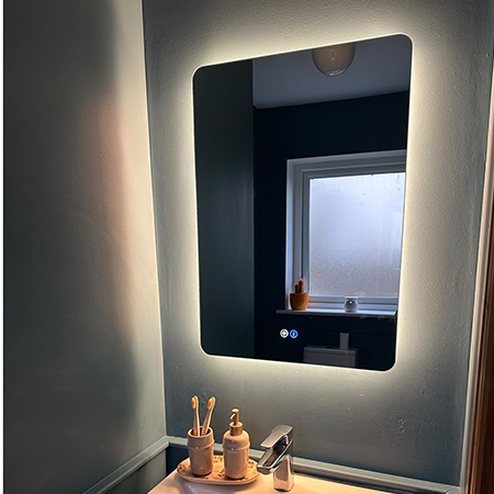 small 500x700mm bathroom mirror with a warm white glow illuminated above a bathroom sink