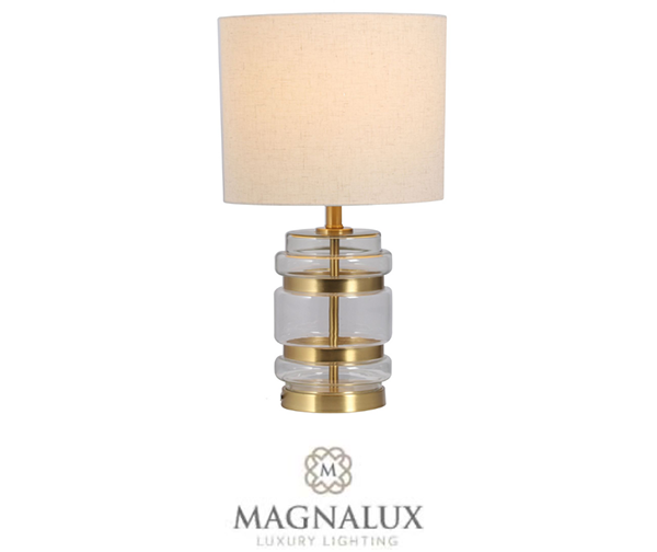 satin brass table lamp with crystal decorative features and a round fabric shade