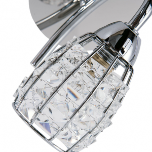 closeup detail of clear crystal shade of a polished chrome finish wall light