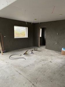 shell of a freshly plastered kitchen with three light fitting power outlets