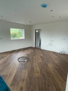 kitchen with a wooden floor ready for kitchen island installation