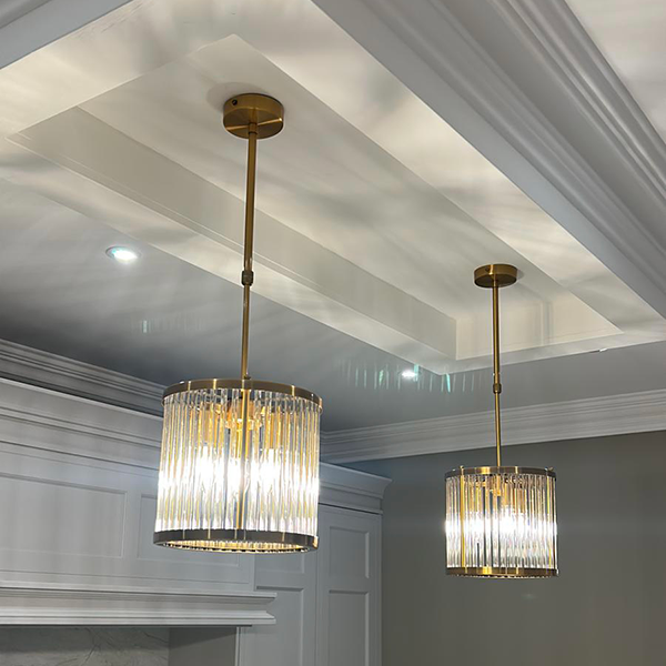 two gold luxury pendants with crystal enclosures fixed from a kitchen ceiling
